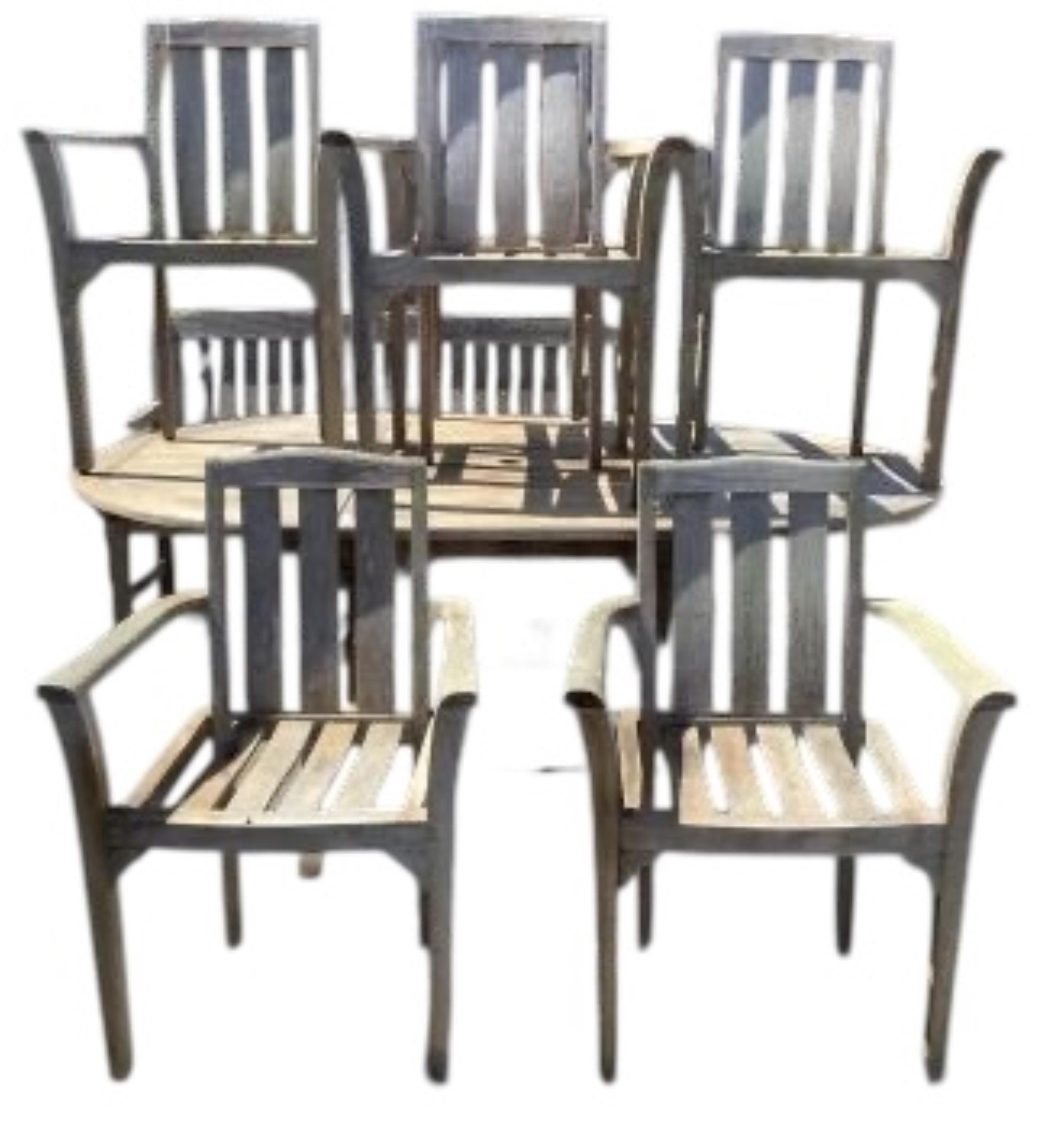 Six Sherwood teak elbow chairs, a weathered teak oval extending garden table, 181cm extended, depth 120cm, height 74cm and a lazy Susan